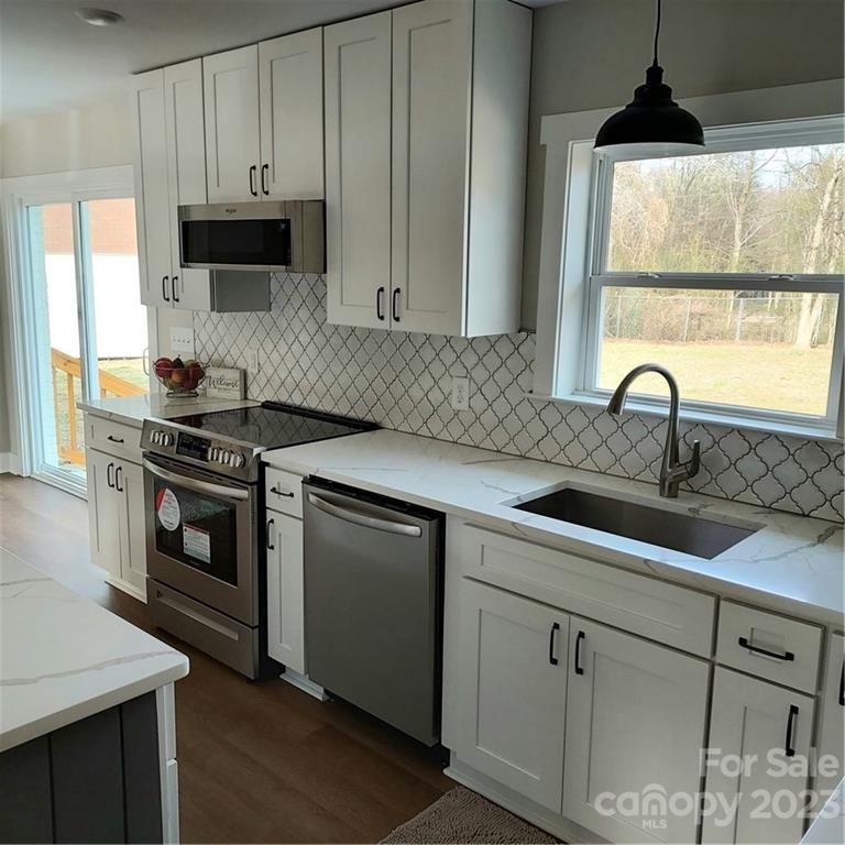5601 Medlin Road Monroe, NC 28112 - Photo 13 of 29 a kitchen with a sink stove and cabinets