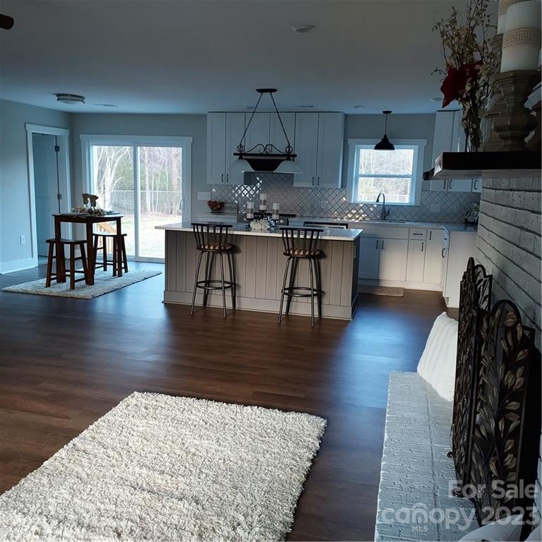 5601 Medlin Road Monroe, NC 28112 - Photo 7 of 29 a living room with fireplace furniture and a wooden floor