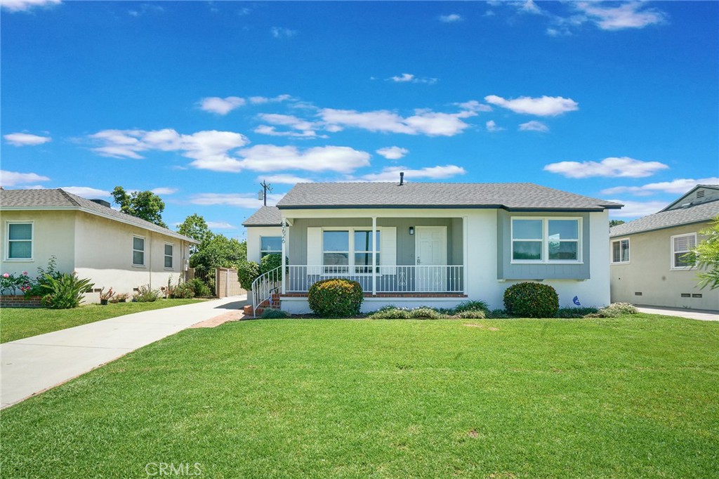 a view of a house with a yard and plants