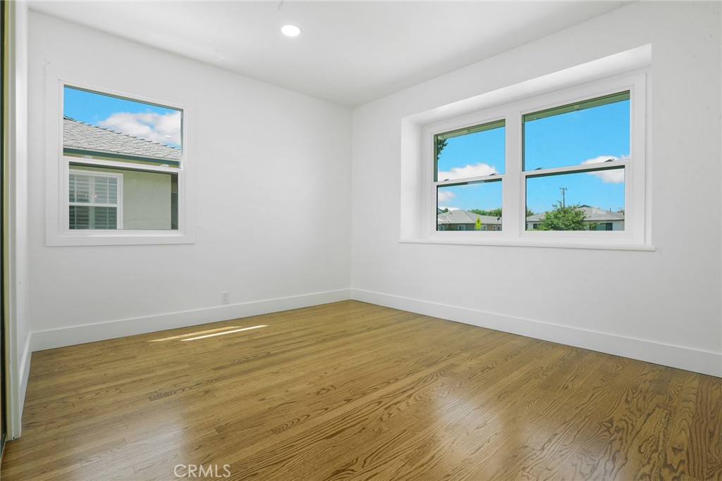 5626 Lenore Avenue Arcadia, CA 91006 - Photo 13 of 23 a view of an empty room with wooden floor and a window