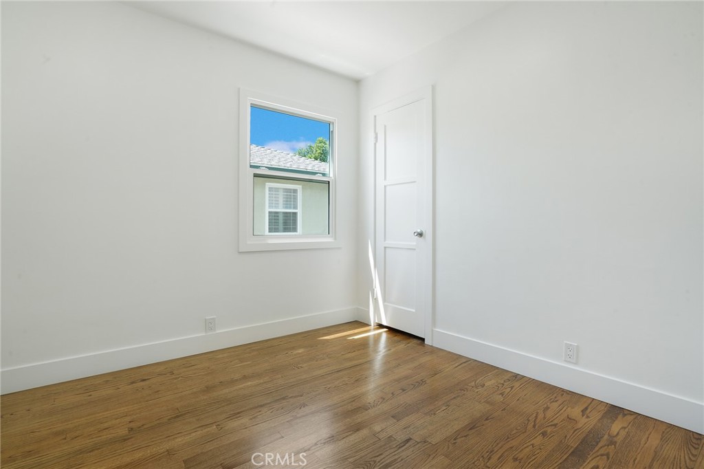 5626 Lenore Avenue Arcadia, CA 91006 - Photo 15 of 23 a view of an empty room with wooden floor and a window