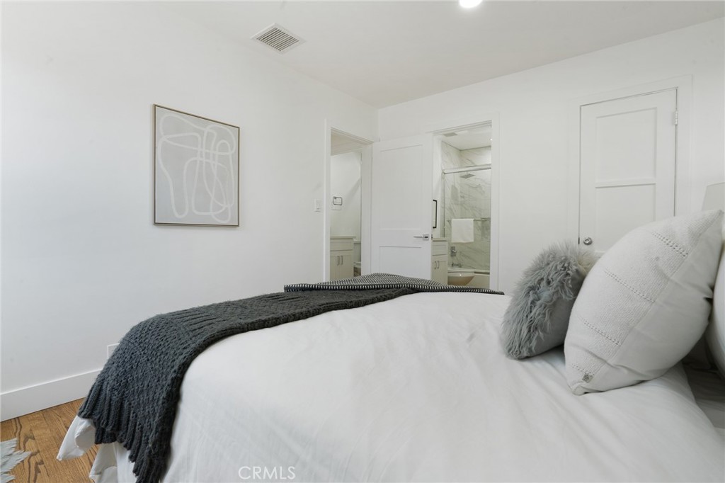 5626 Lenore Avenue Arcadia, CA 91006 - Photo 10 of 23 a bedroom with a large bed and a chandelier