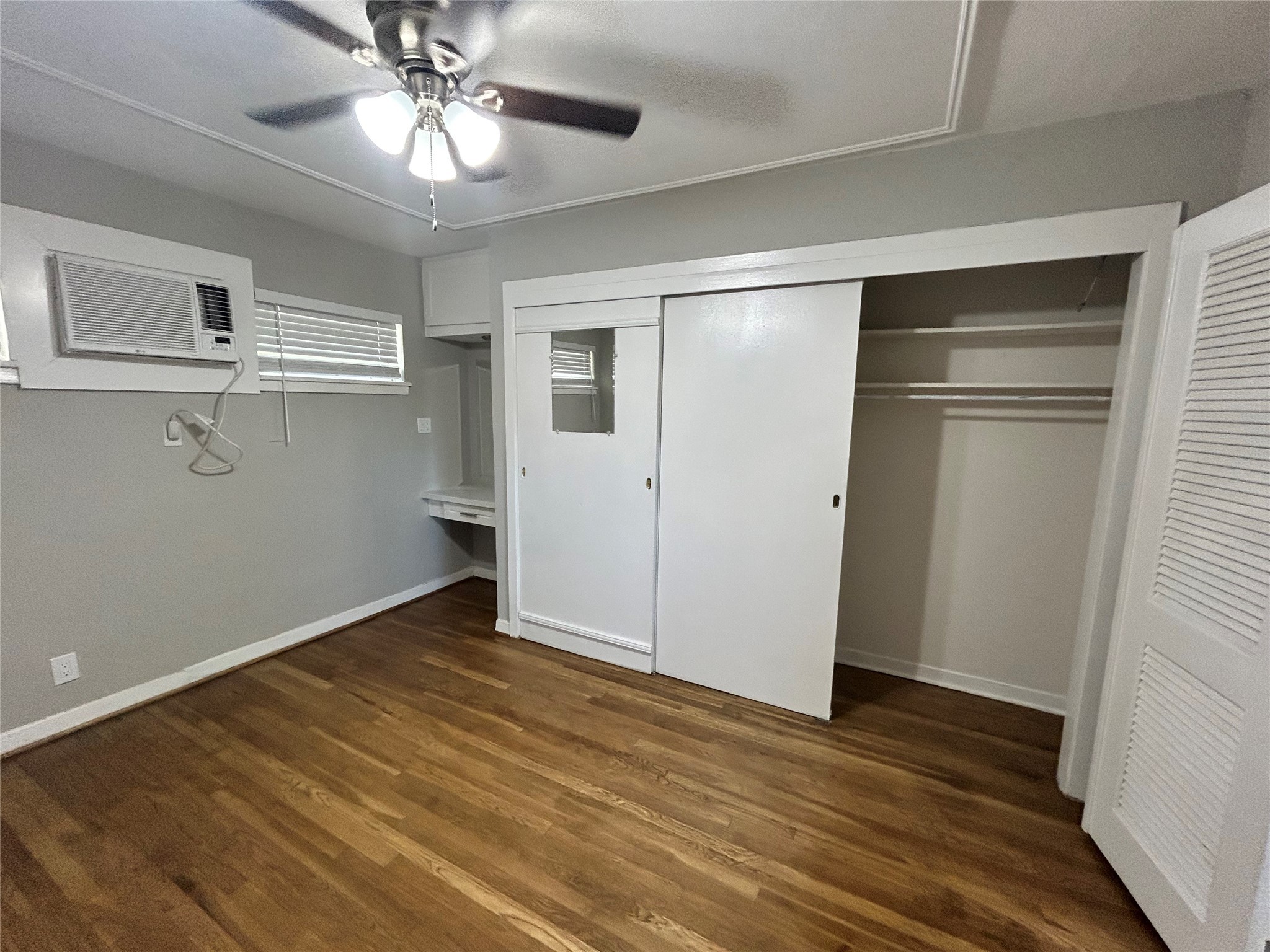 3520 Garrott Street, Unit 2 Houston, TX 77006 - Photo 7 of 14 wooden floor in an empty room with a window