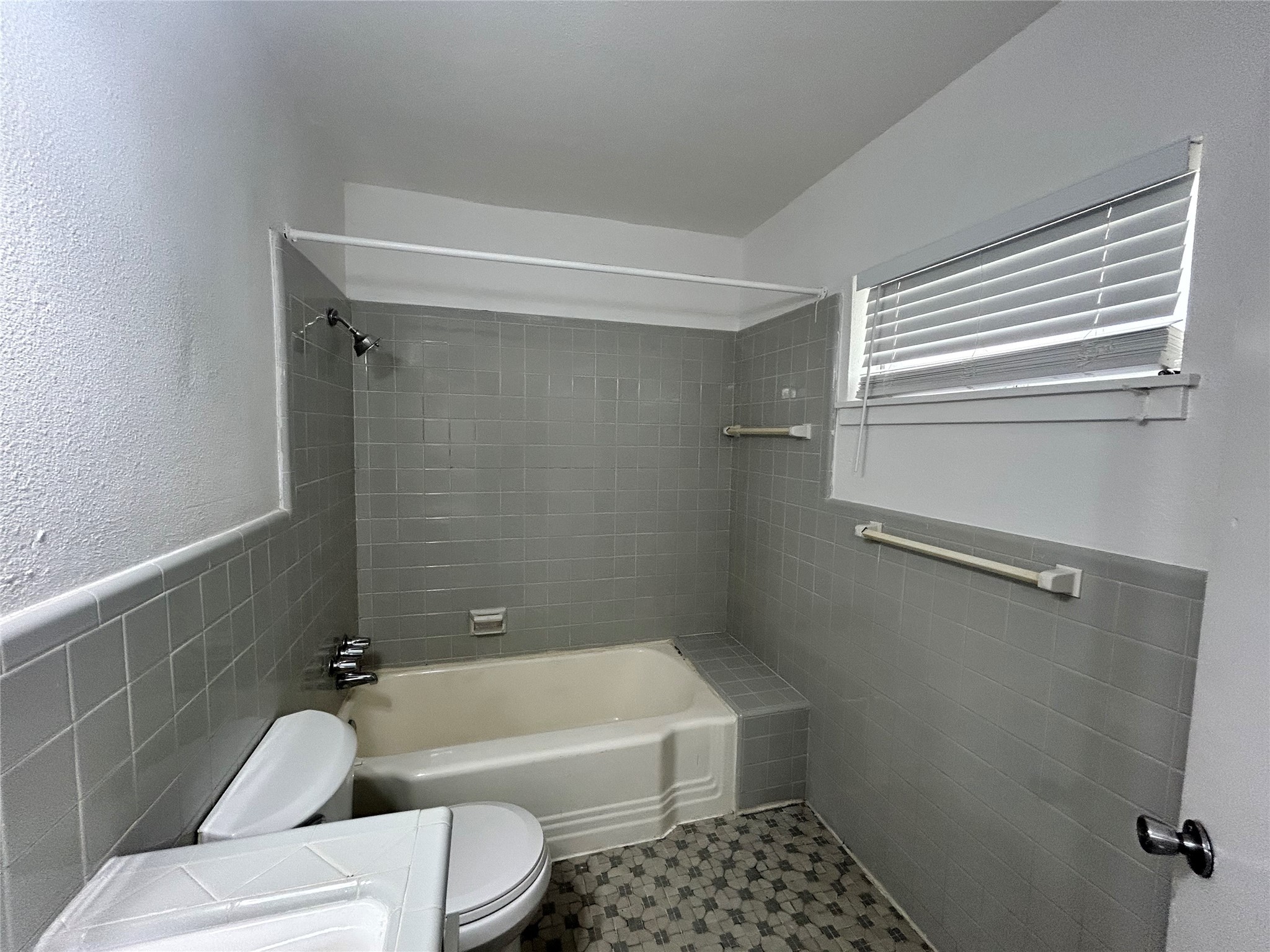 3520 Garrott Street, Unit 2 Houston, TX 77006 - Photo 9 of 14 a bathroom with a toilet and a bathtub