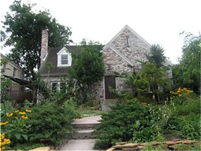 a view of a house with a yard and garden