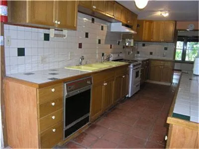 a kitchen with stainless steel appliances granite countertop a sink a stove and a refrigerator
