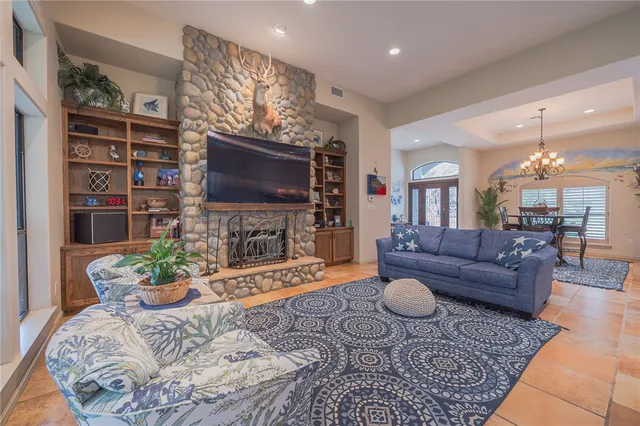a living room with furniture a flat screen tv and a potted plant