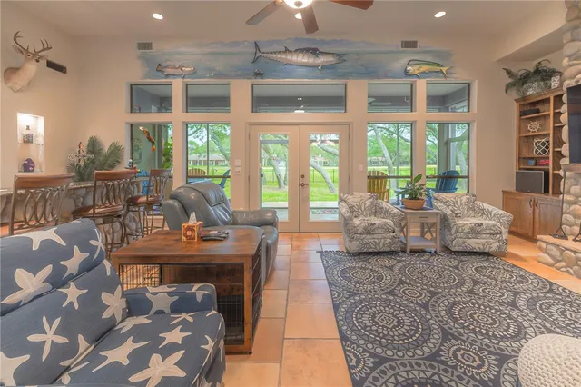 a living room with furniture and large windows