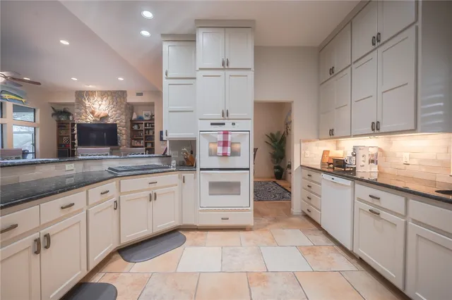 a kitchen with granite countertop a sink and cabinets