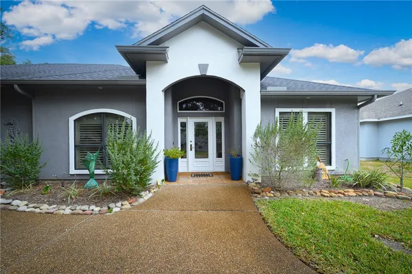 a front view of a house with garden