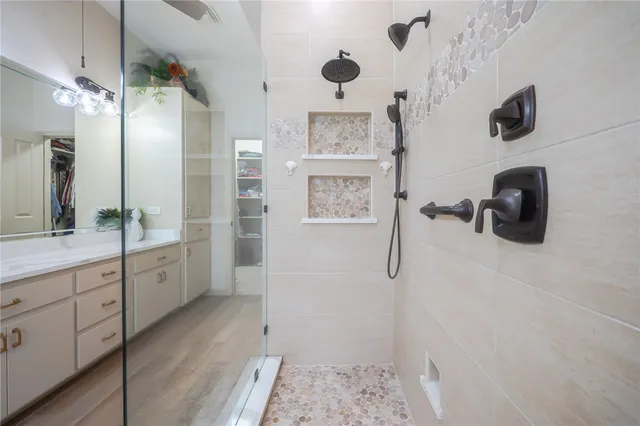 a bathroom with a granite countertop sink a toilet and shower