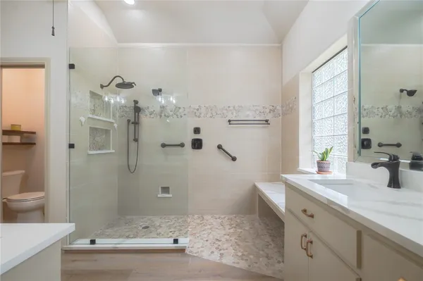 a bathroom with a double vanity sink a mirror and a shower