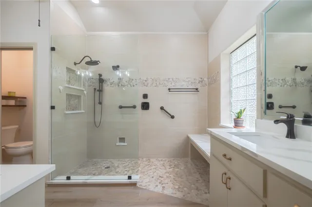a bathroom with a double vanity sink a mirror and a shower