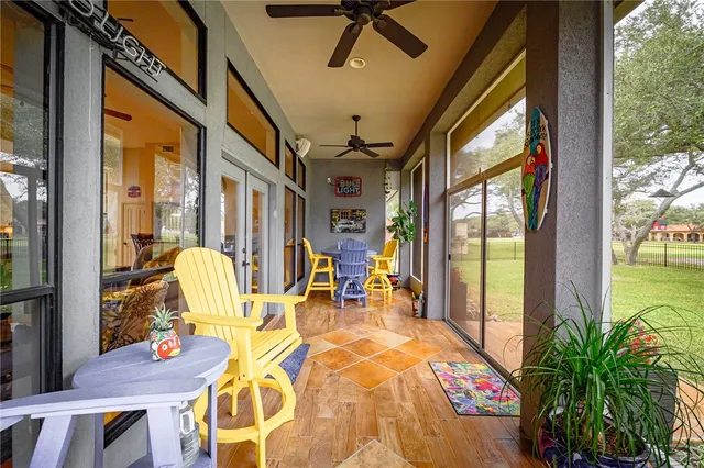 a view of a house with backyard and a tree