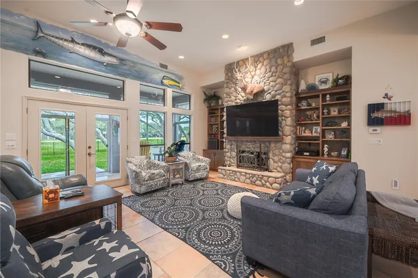 a living room with furniture a flat screen tv and a large window