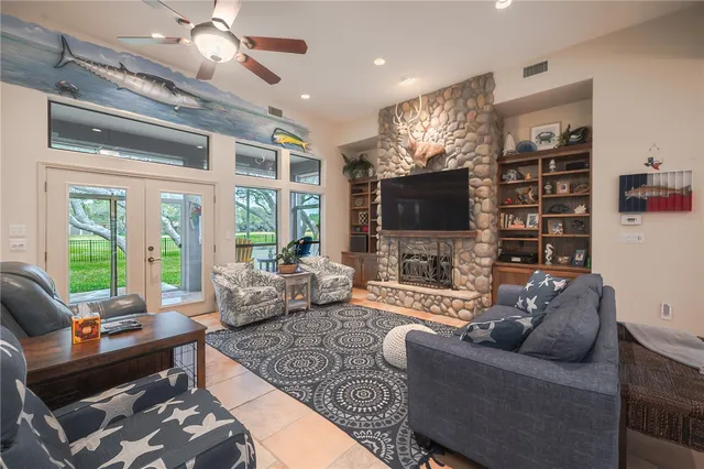 a living room with furniture a flat screen tv and a large window