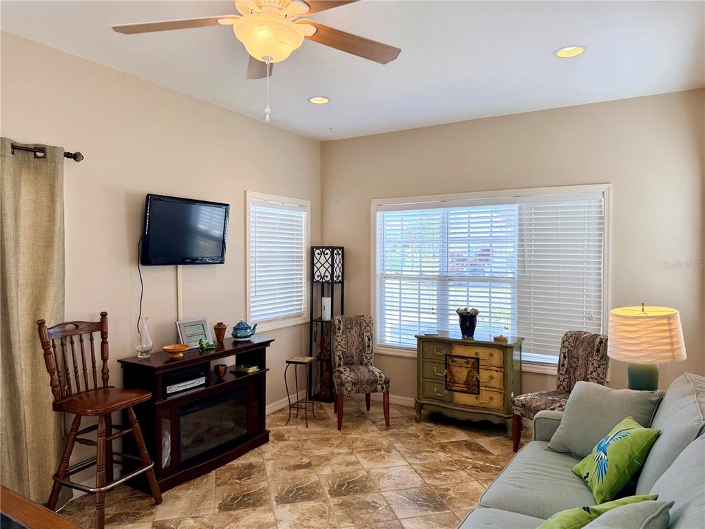 9588 Southeast 47th Way Webster, FL 33597 - Photo 15 of 43 a living room with furniture and a flat screen tv