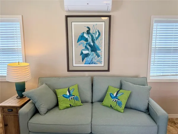 a living room with a couch and a window