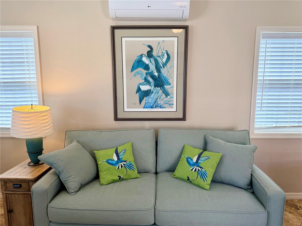 9588 Southeast 47th Way Webster, FL 33597 - Photo 17 of 43 a living room with a couch and a window