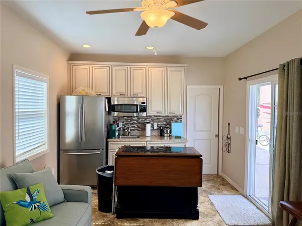 a kitchen with stainless steel appliances granite countertop a refrigerator a stove and a refrigerator