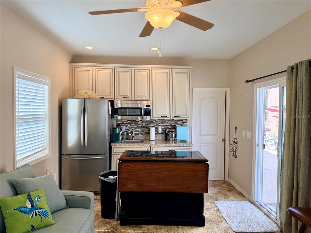 9588 Southeast 47th Way Webster, FL 33597 - Photo 19 of 43 a kitchen with stainless steel appliances granite countertop a refrigerator a stove and a refrigerator