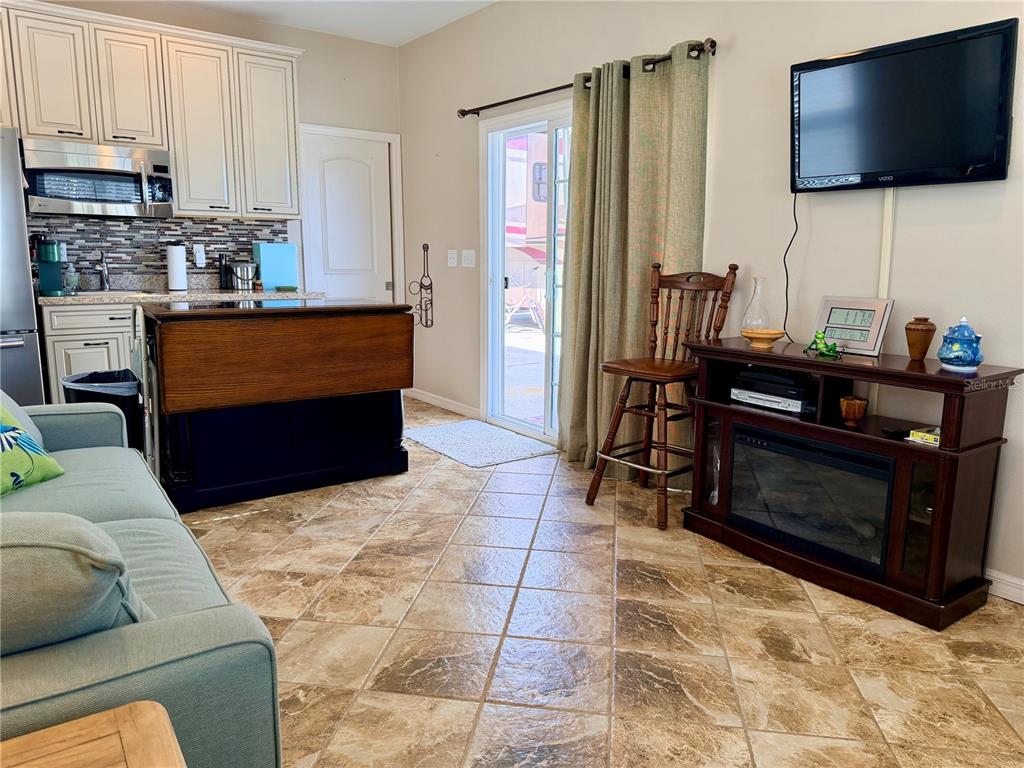 9588 Southeast 47th Way Webster, FL 33597 - Photo 22 of 43 a living room with furniture and a flat screen tv