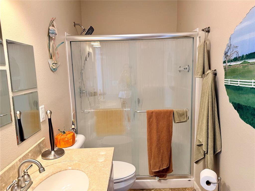 9588 Southeast 47th Way Webster, FL 33597 - Photo 25 of 43 a bathroom with a sink toilet and shower