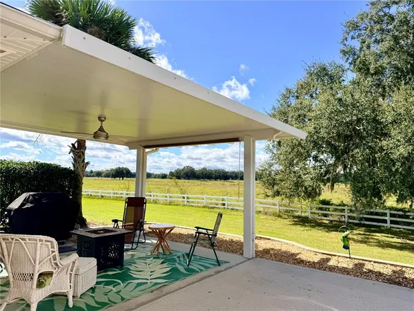 a view of swimming pool with outdoor seating space
