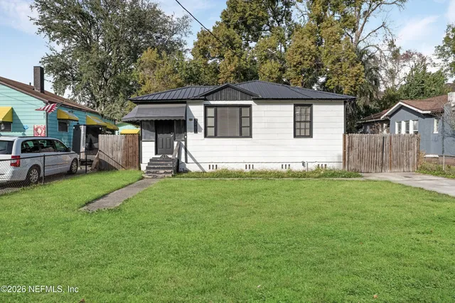 a front view of house with yard and green space