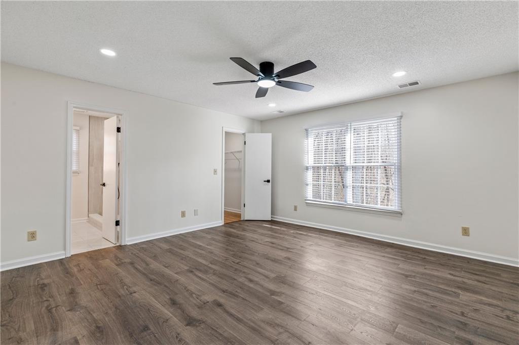 2095 Uniwattee Trail Southeast Dacula, GA 30019 - Photo 12 of 20 wooden floor in an empty room with a window