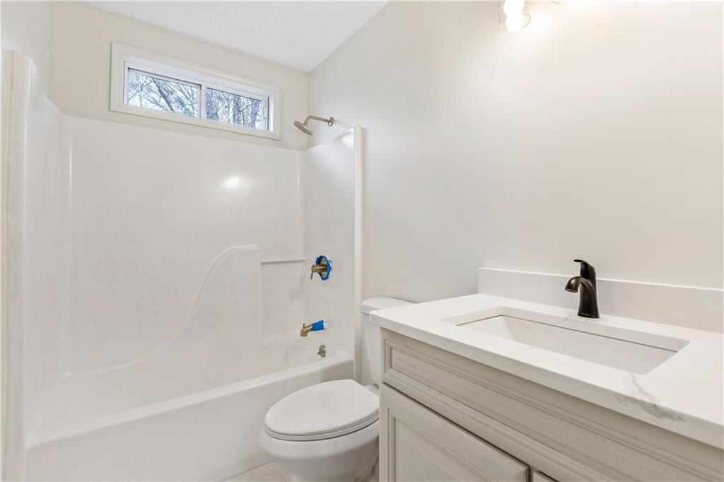 2095 Uniwattee Trail Southeast Dacula, GA 30019 - Photo 9 of 20 a bathroom with a sink a toilet and shower
