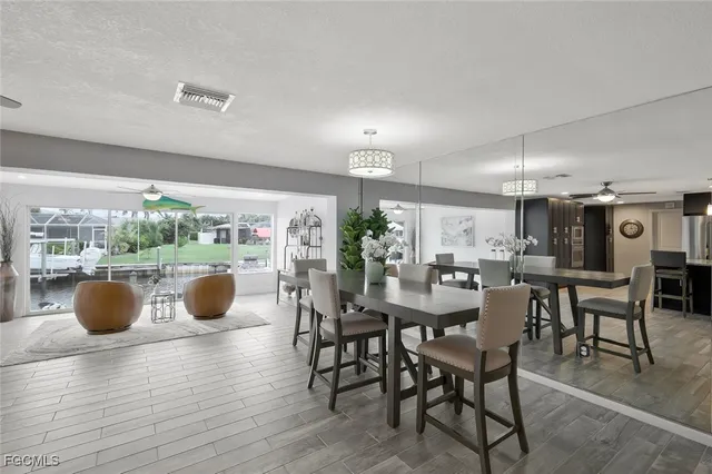 a view of a dining room with furniture and chandelier