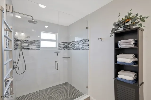 a bathroom with a shower and a sink