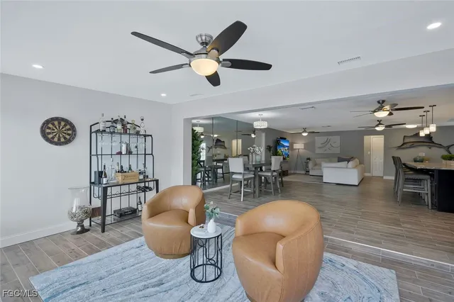 a living room with furniture and kitchen view