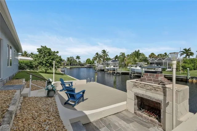 a view of a lake with couches chairs and a table
