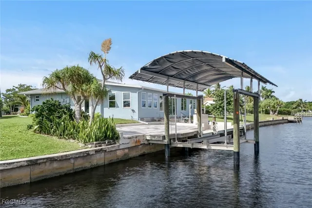 a view of house with yard outdoor seating and lake view