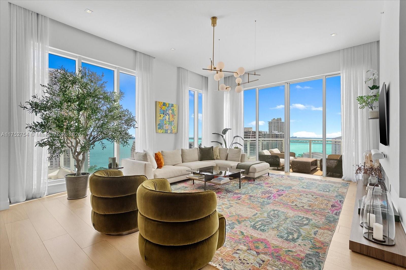 a living room with couch a flat screen tv and a large window