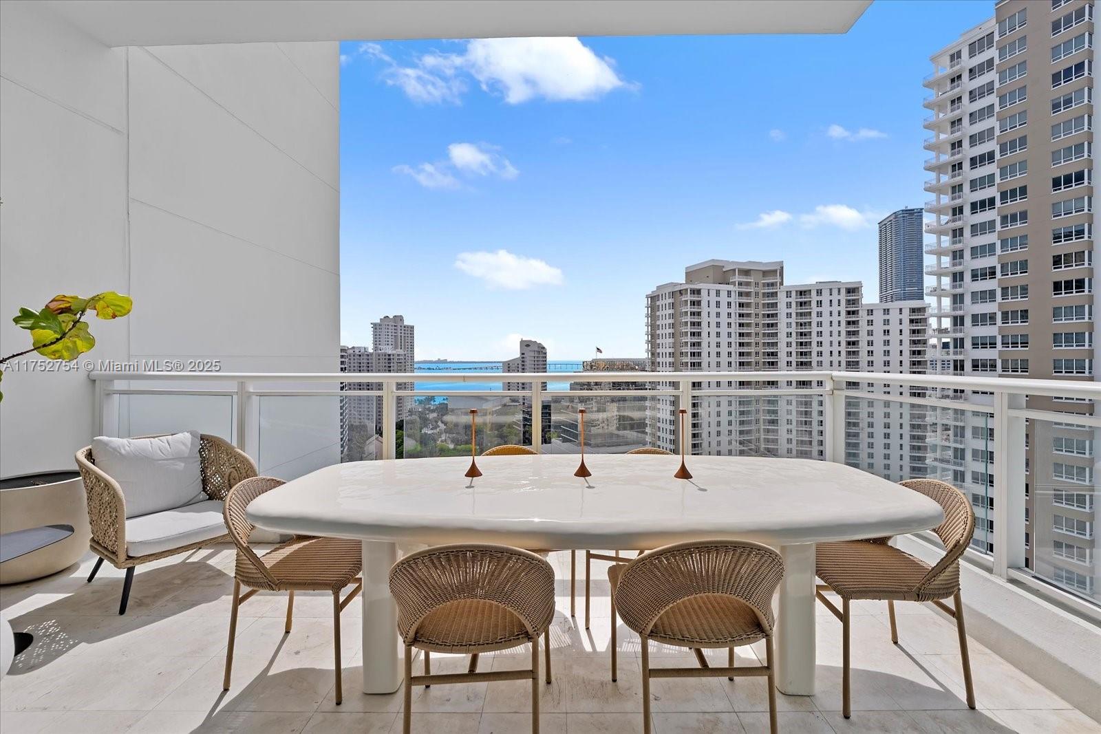 900 Brickell Key Boulevard, Unit 1604 Miami, FL 33131 - Photo 11 of 49 a view of a dining room with furniture and chandelier