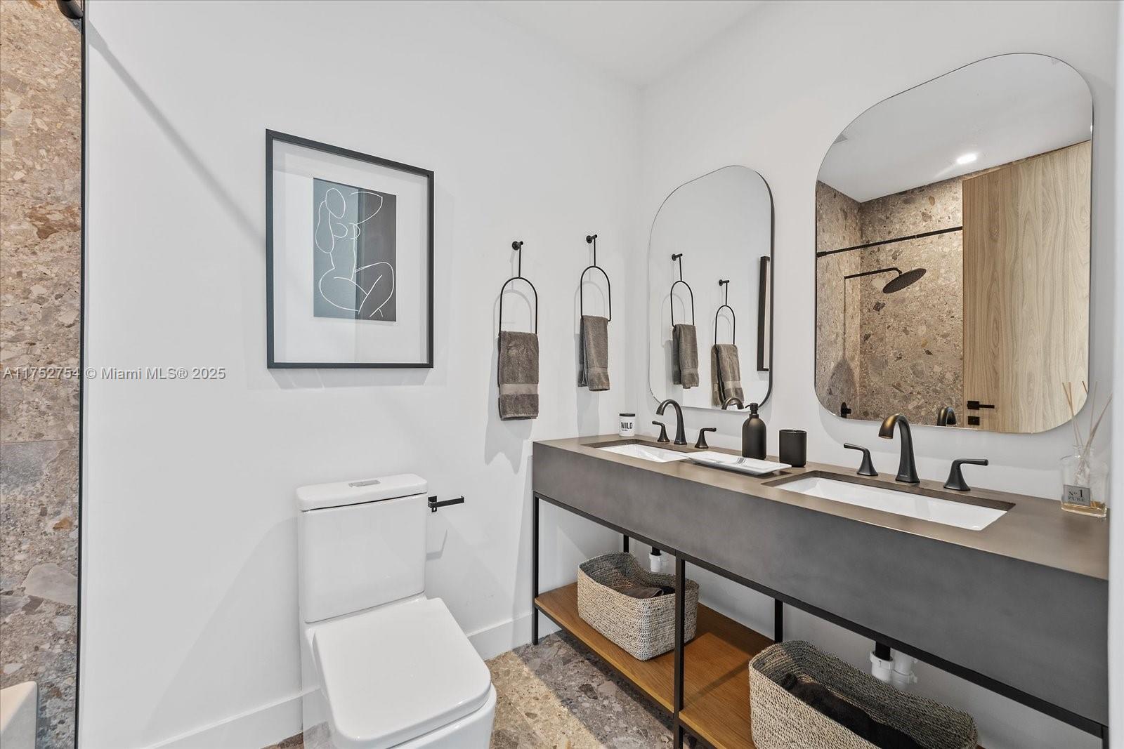 900 Brickell Key Boulevard, Unit 1604 Miami, FL 33131 - Photo 25 of 49 a bathroom with a double vanity sink mirror and toilet