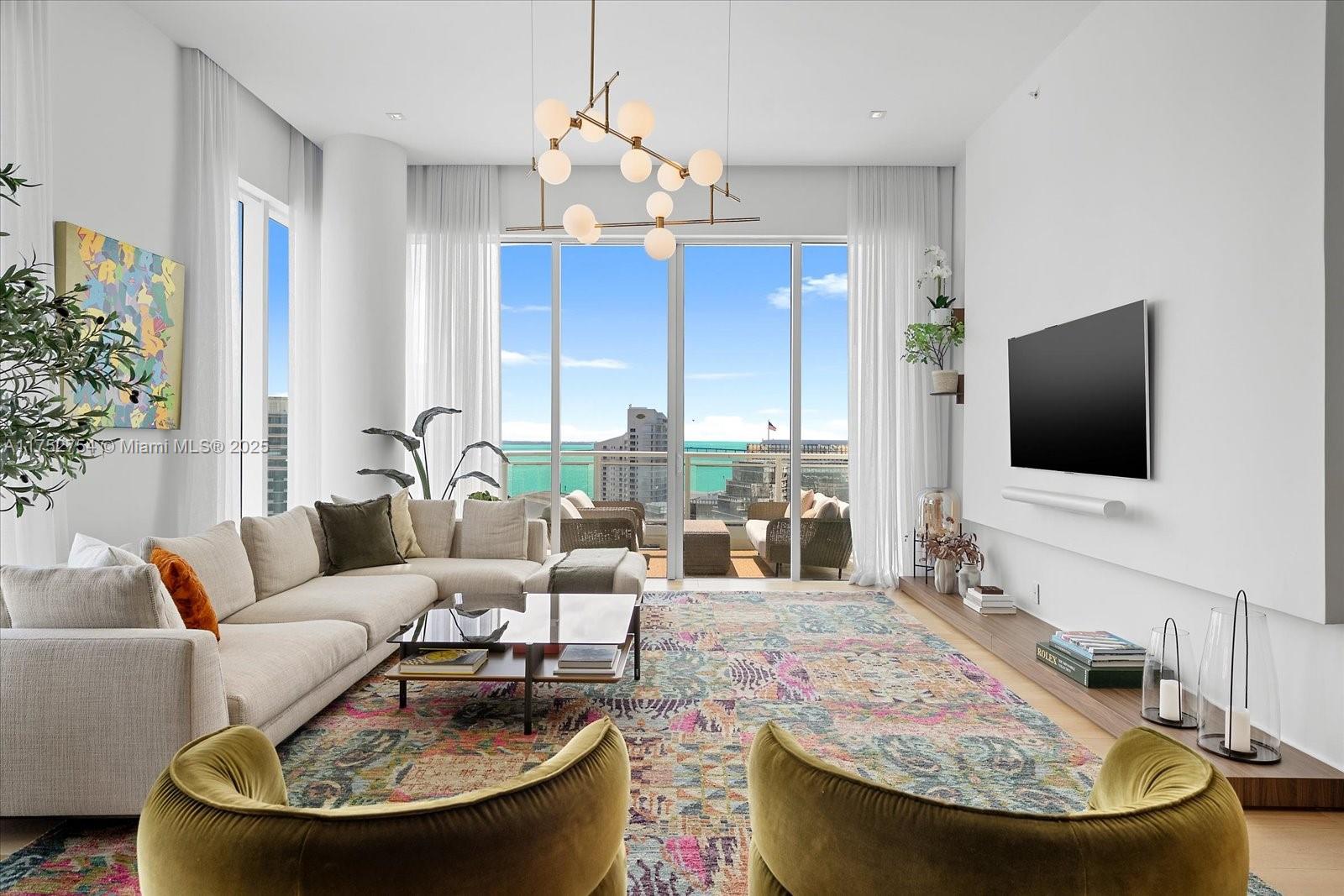 900 Brickell Key Boulevard, Unit 1604 Miami, FL 33131 - Photo 3 of 49 a living room with furniture and a flat screen tv