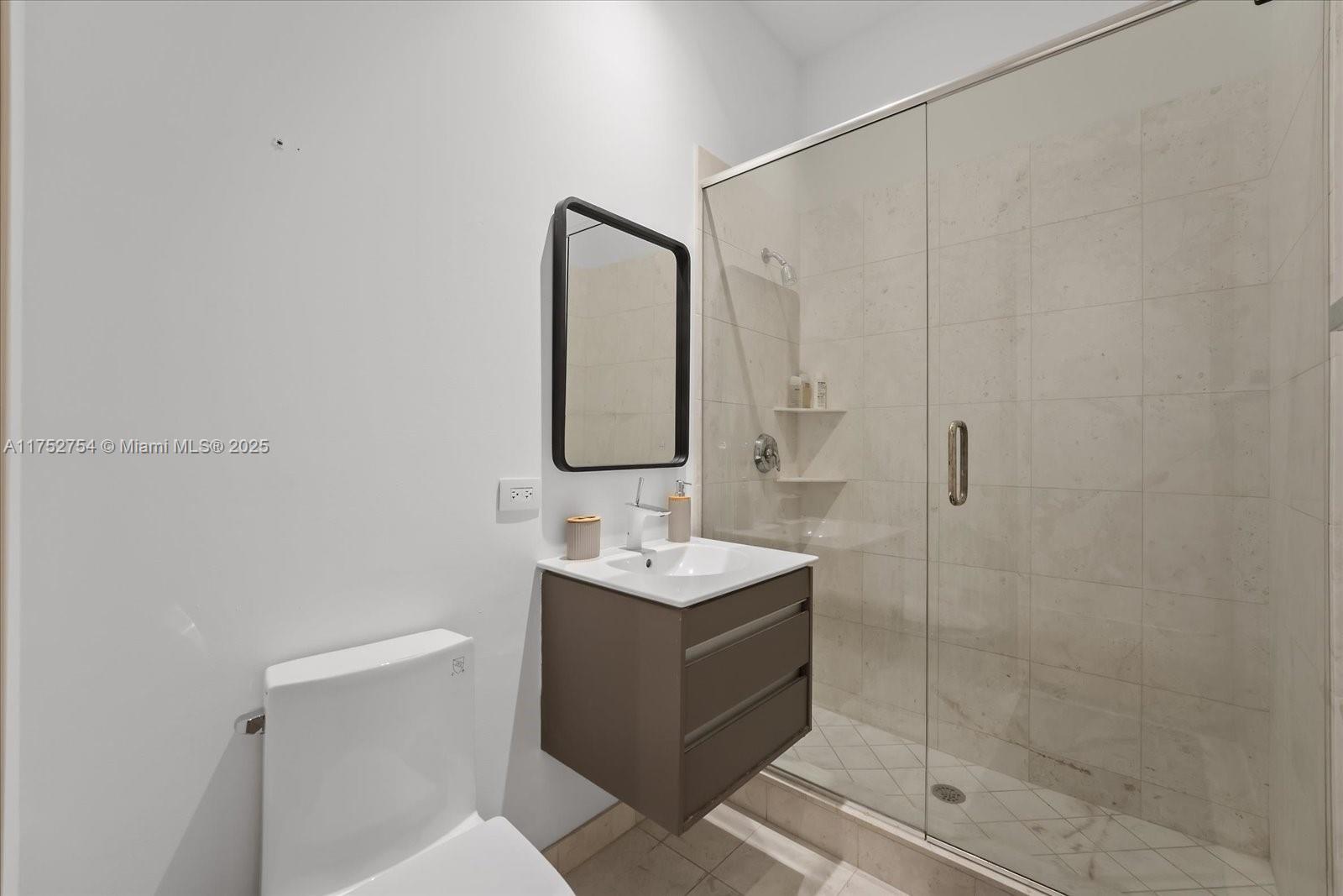 900 Brickell Key Boulevard, Unit 1604 Miami, FL 33131 - Photo 34 of 49 a bathroom with a sink toilet and shower