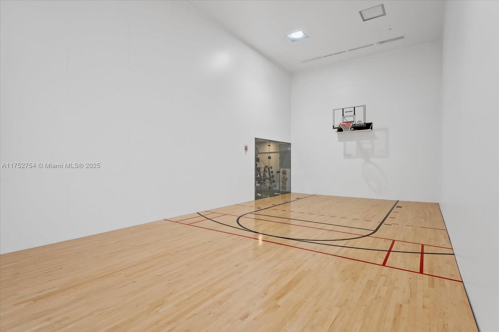 900 Brickell Key Boulevard, Unit 1604 Miami, FL 33131 - Photo 44 of 49 a view of a room with a white wooden floor