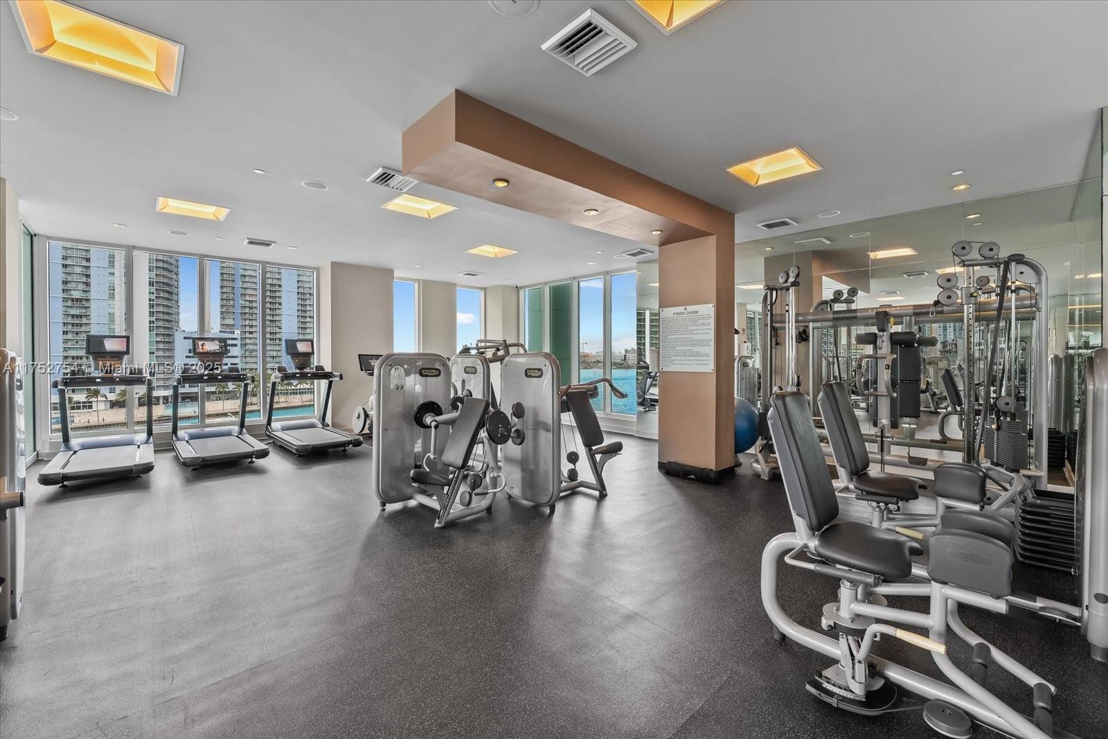 900 Brickell Key Boulevard, Unit 1604 Miami, FL 33131 - Photo 45 of 49 a view of a room with gym equipment