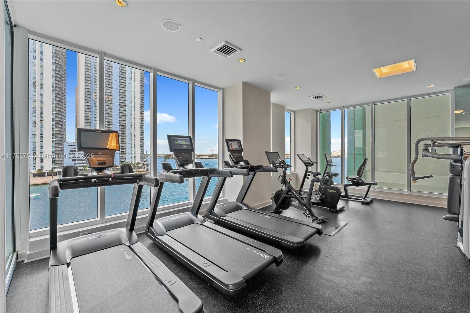 900 Brickell Key Boulevard, Unit 1604 Miami, FL 33131 - Photo 46 of 49 a view of a room with gym equipment