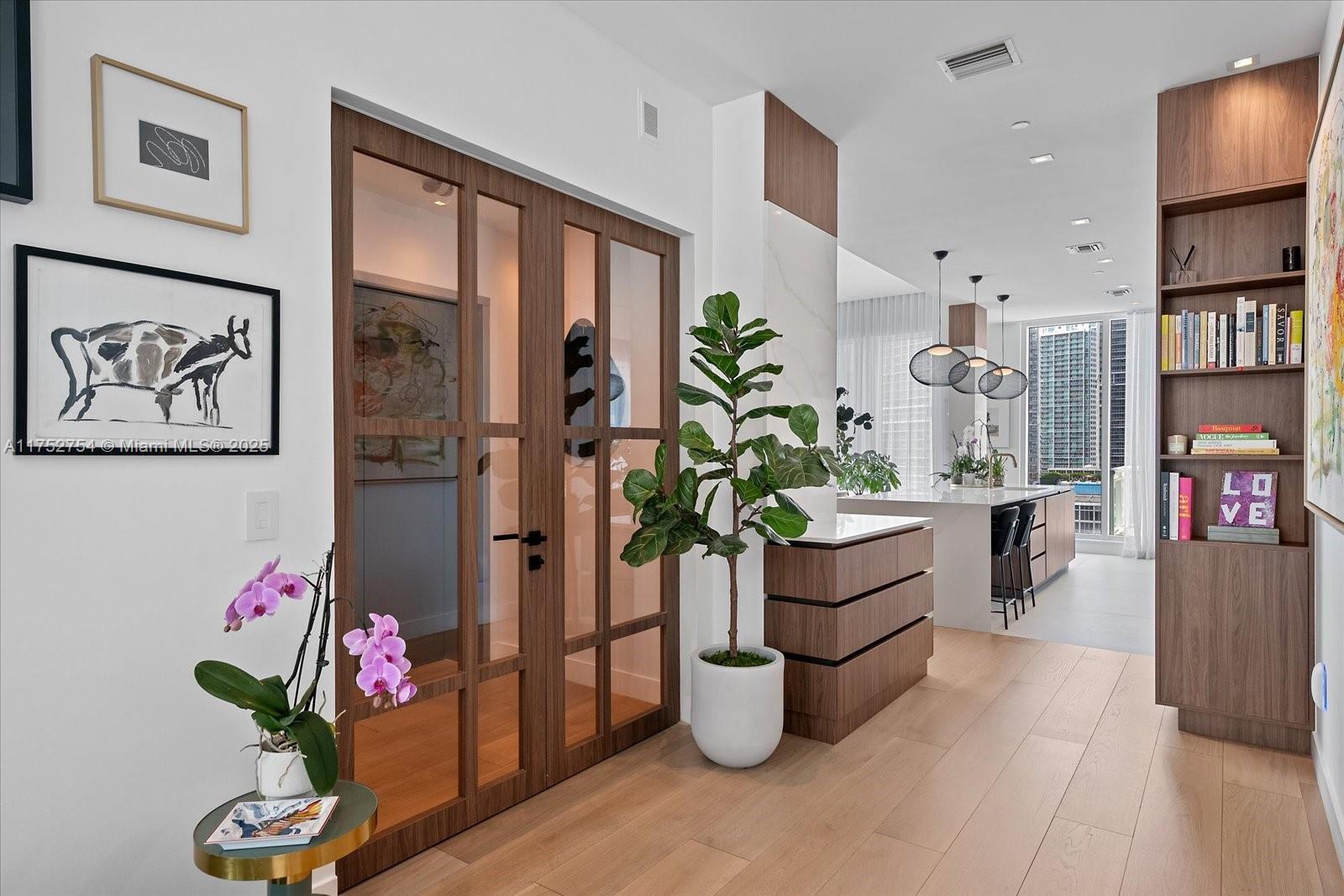 900 Brickell Key Boulevard, Unit 1604 Miami, FL 33131 - Photo 7 of 49 a living room with furniture and a potted plant