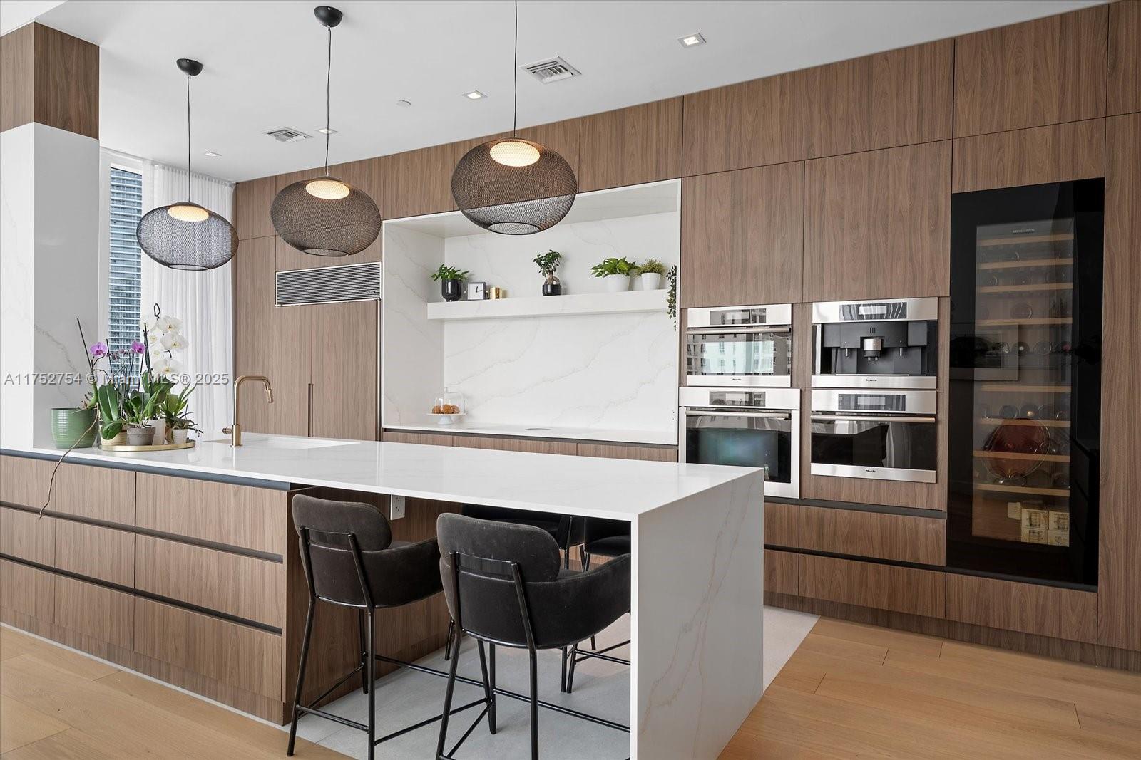 900 Brickell Key Boulevard, Unit 1604 Miami, FL 33131 - Photo 8 of 49 a kitchen with a table and chairs