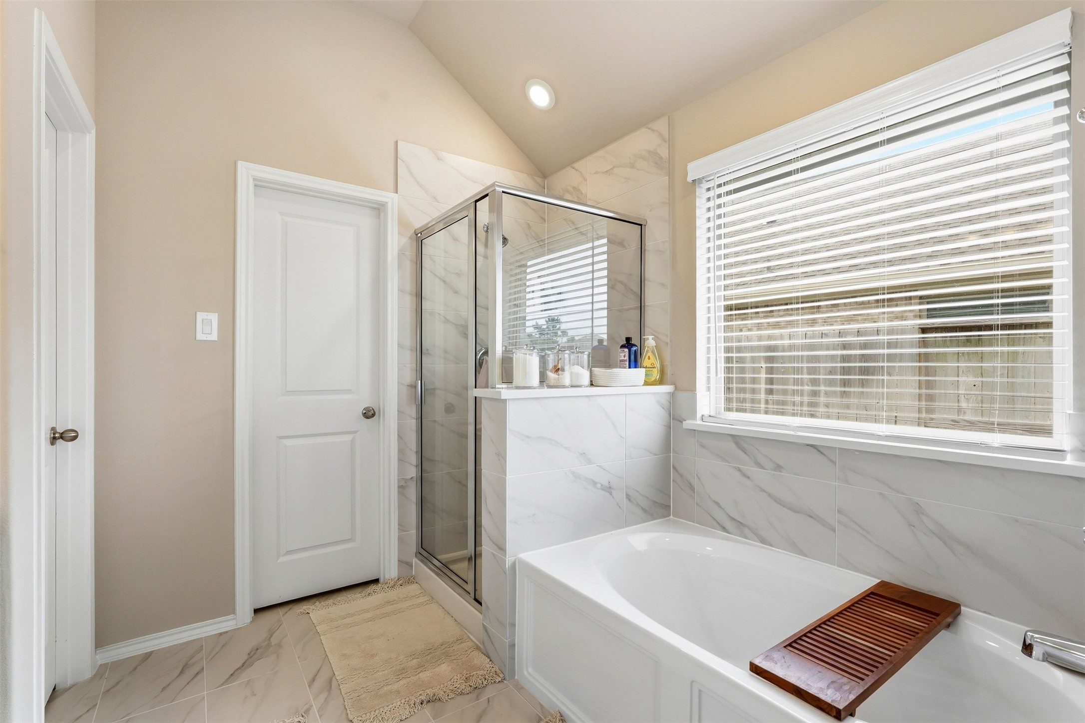 10526 Cabot Trail Rosharon, TX 77583 - Photo 15 of 24 a bathroom with a bathtub and a window