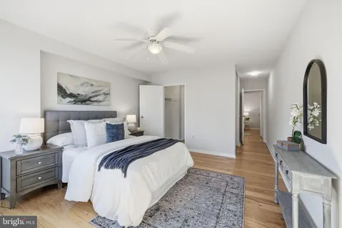 a spacious bedroom with a bed and a dresser