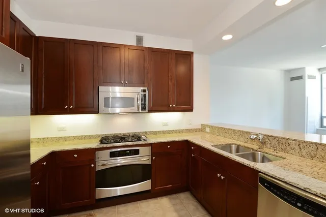 a kitchen with a sink and a stove top oven