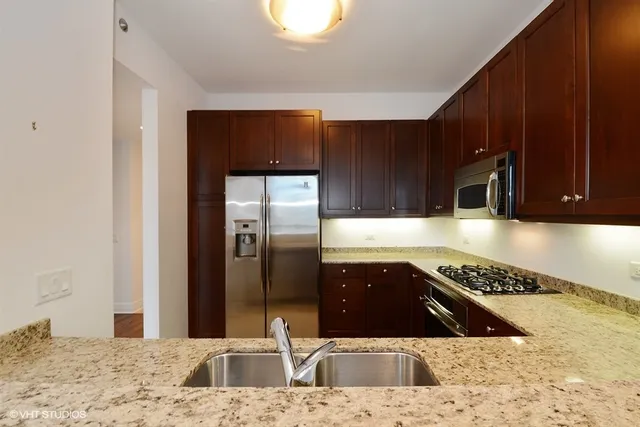 a kitchen with a refrigerator and a sink